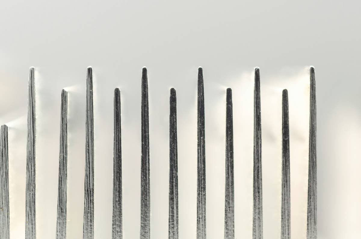 Professional stylist using a high-quality hair styling comb on damp hair